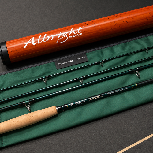 Albright Tradewind fly fishing rod set laid out on a dark surface with a green rod bag and a wooden presentation tube. The rod features a black handle, dark green shafts, and silver guides, with the Albright Tradewind branding clearly visible.